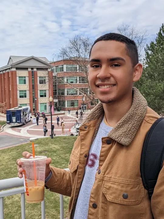 Campus portrait holding an iced coffee