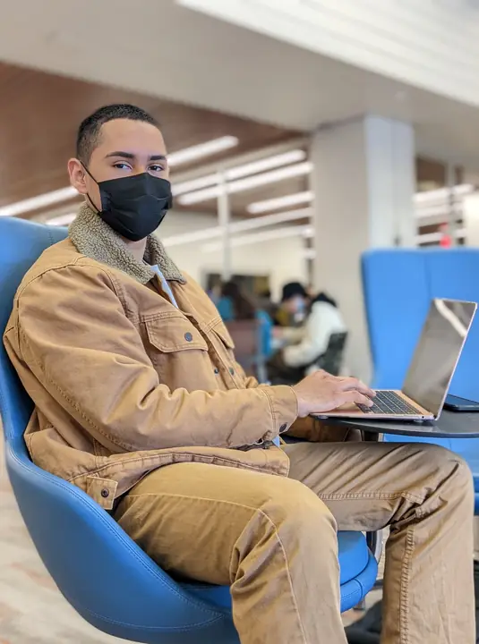 Student working on a laptop in a library
