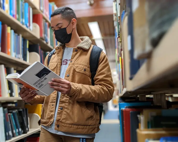 Portrait in a library aisle
