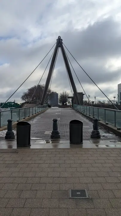 Pedestrian bridge under winter clouds